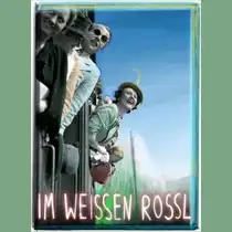 Historical promotional poster for *Im wei&szlig;en R&ouml;ssl*: Several people are leaning out of the windows of a moving train against a blue sky. At the bottom, the title *IM WEISSEN ROSSL* is written in large, bright letters.